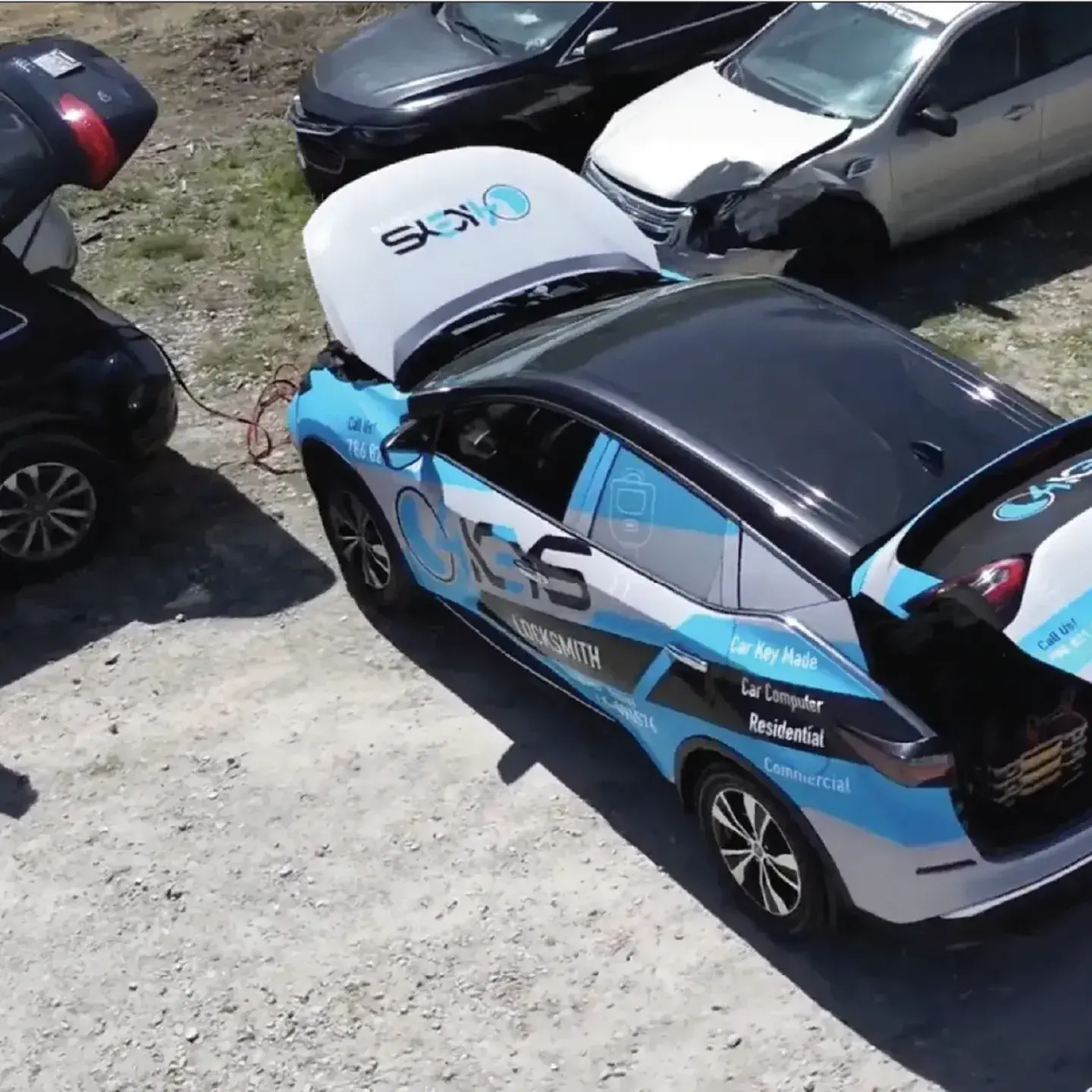 Emergency locksmith responding to car lockout at night with mobile van